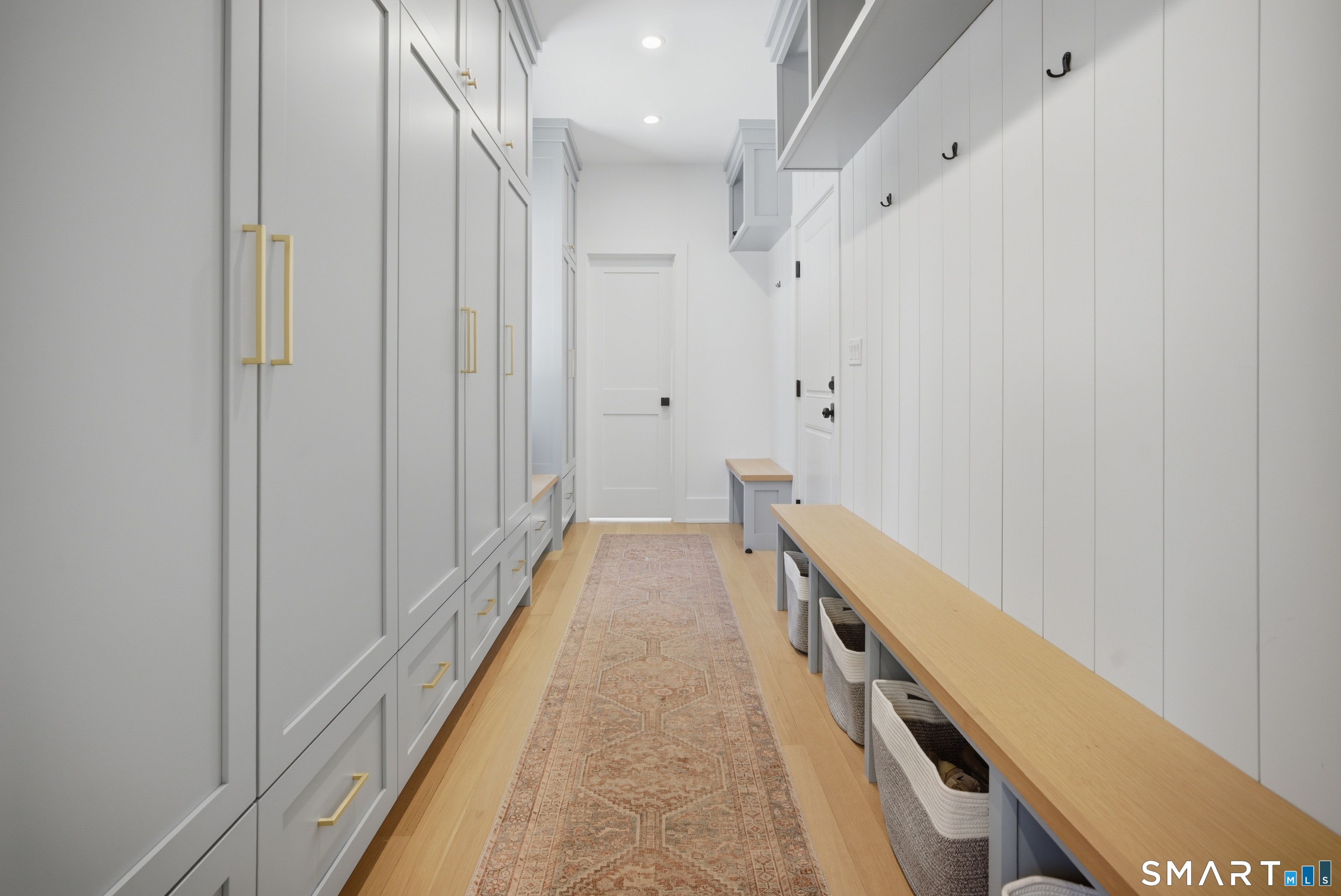 196 Robin Lane Fairfield, CT 06824 - Photo 22 of 37 a view of a hallway with wooden floor and staircase