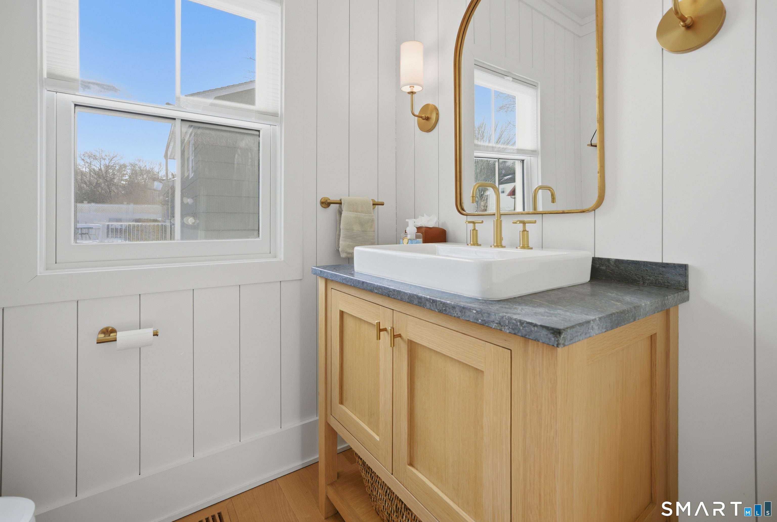 196 Robin Lane Fairfield, CT 06824 - Photo 23 of 37 a bathroom with a granite countertop sink and a mirror