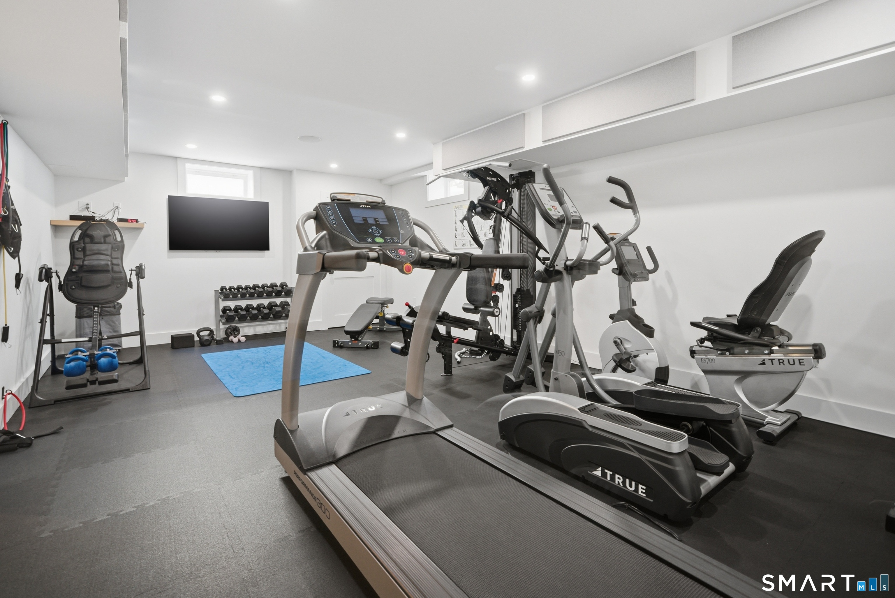 196 Robin Lane Fairfield, CT 06824 - Photo 32 of 37 a room with gym equipment and a flat screen tv