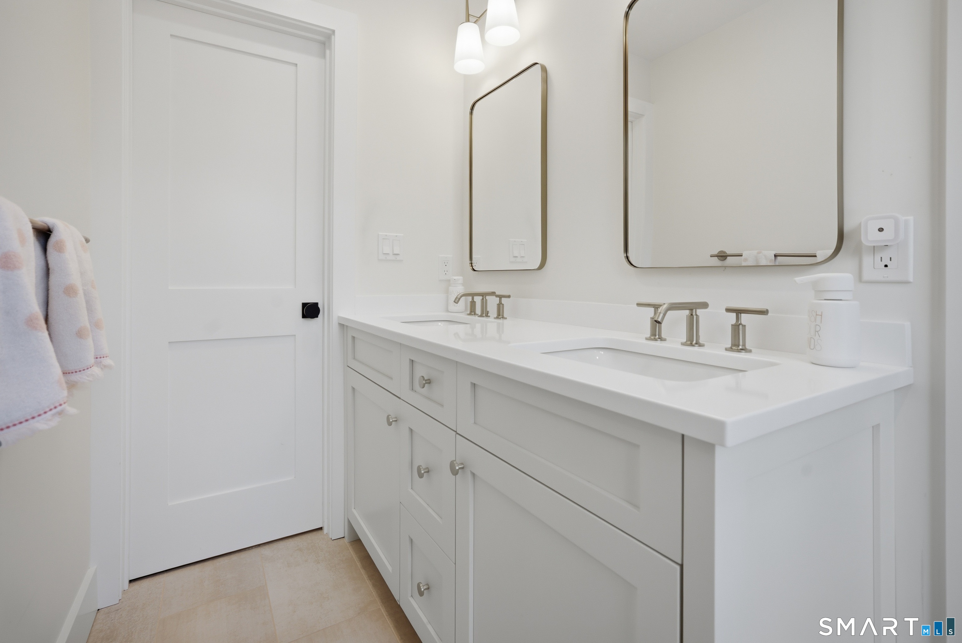 196 Robin Lane Fairfield, CT 06824 - Photo 9 of 37 a bathroom with double vanity sink and two mirror