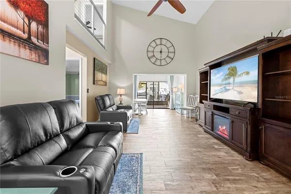 a living room with furniture a fireplace and a large window