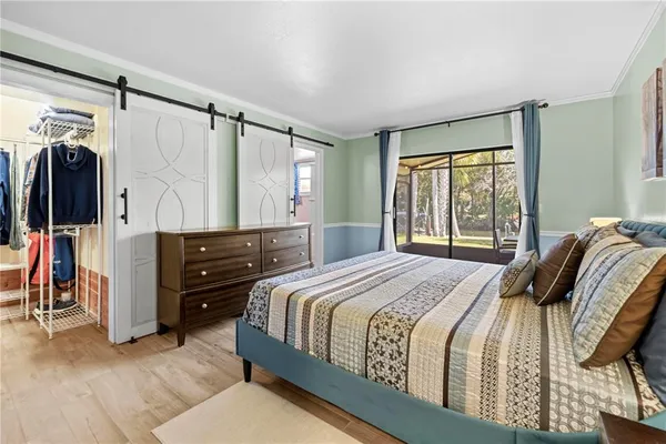 a bedroom with a bed and a ceiling fan