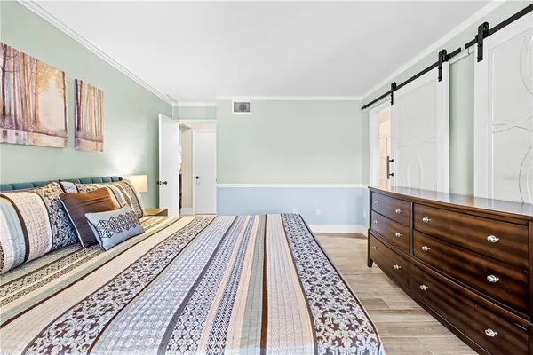 a bedroom with a bed and cabinets