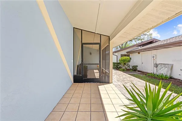 a view of a livingroom with furniture a flat screen tv and a wooden floor