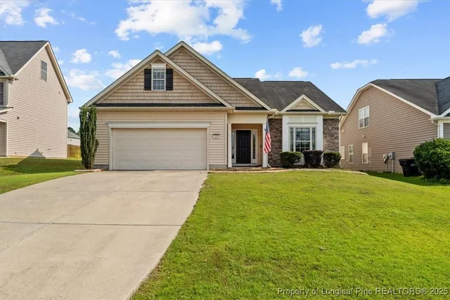 a front view of a house with a yard and garage