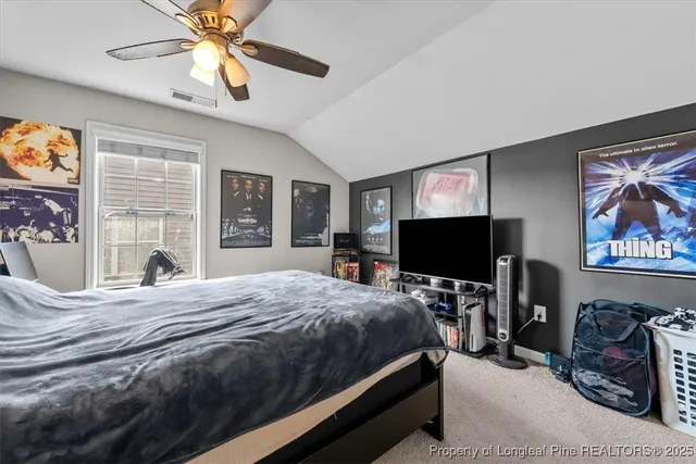 a bedroom with bed tv and window