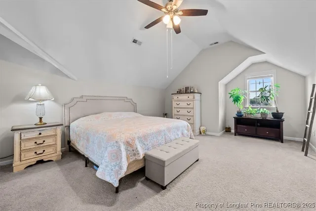 a spacious bedroom with a bed and a chandelier