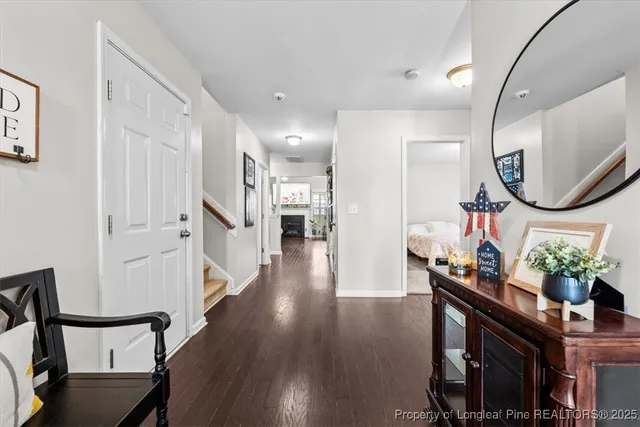 a hallway with wooden floor and furniture