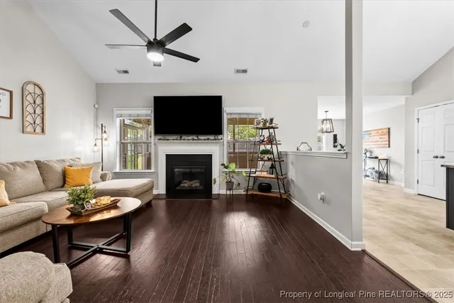 a living room with furniture fireplace and a flat screen tv