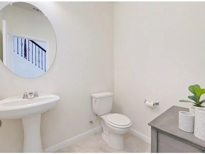 167 Iron Rail Road Dripping Springs, TX 78620 - Photo 10 of 17 Bathroom with toilet, baseboards, and a sink