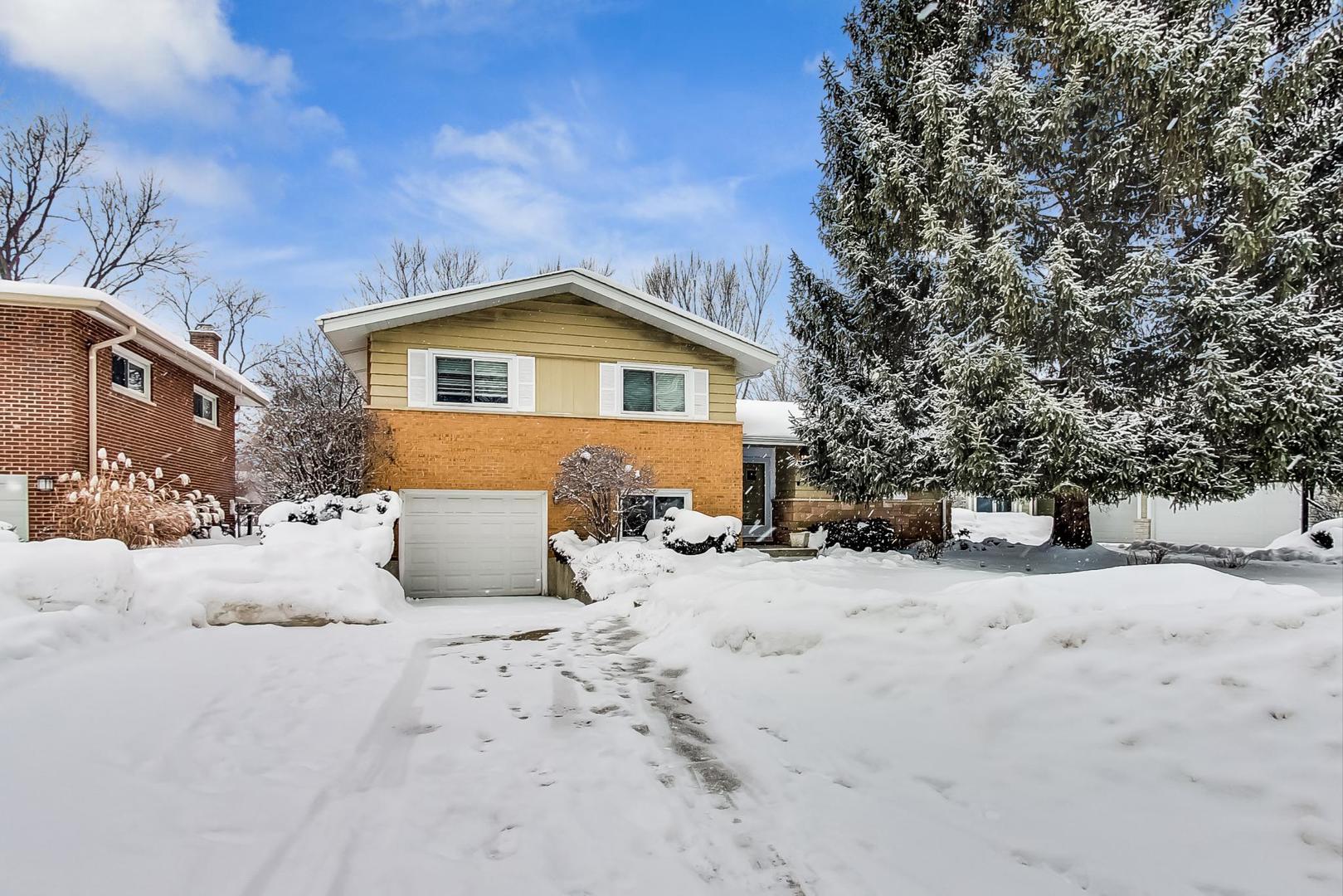 1026 Kenton Road Deerfield, IL 60015 - Photo 1 of 1 a front view of a house with a yard covered in snow