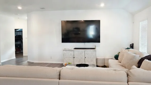 a living room with furniture and a flat screen tv