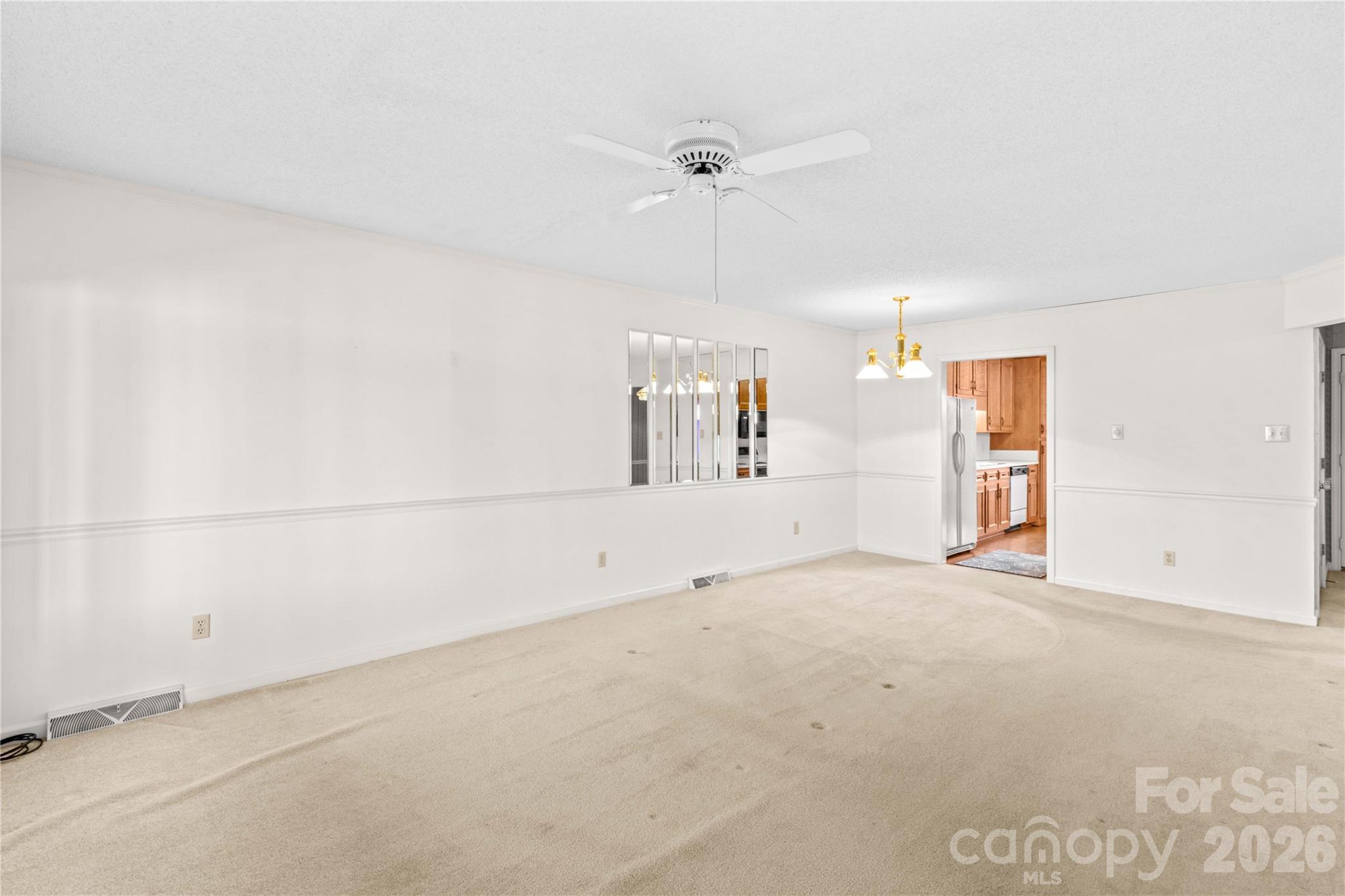 1336 Radio Road Statesville, NC 28625 - Photo 11 of 43 an empty room with chandelier fan and windows