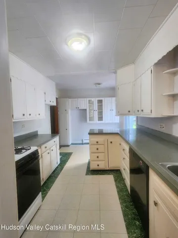 a kitchen with lot of cabinets and stainless steel appliances