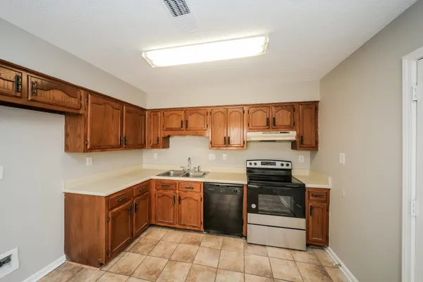 a kitchen with stainless steel appliances a stove sink and cabinets