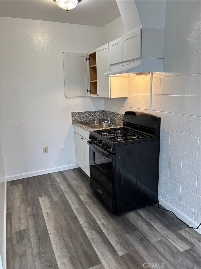 a kitchen with wooden floors and a stove