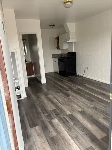 wooden floor in an empty room with a fireplace