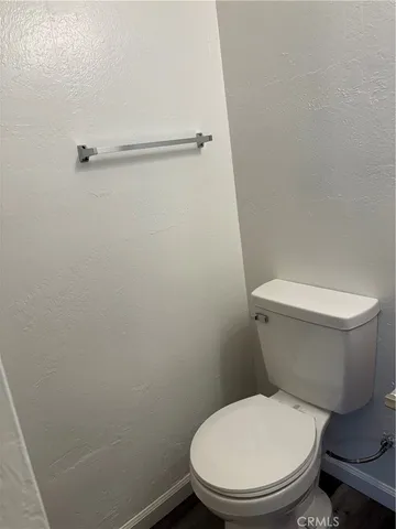 a white toilet sitting next to a shower