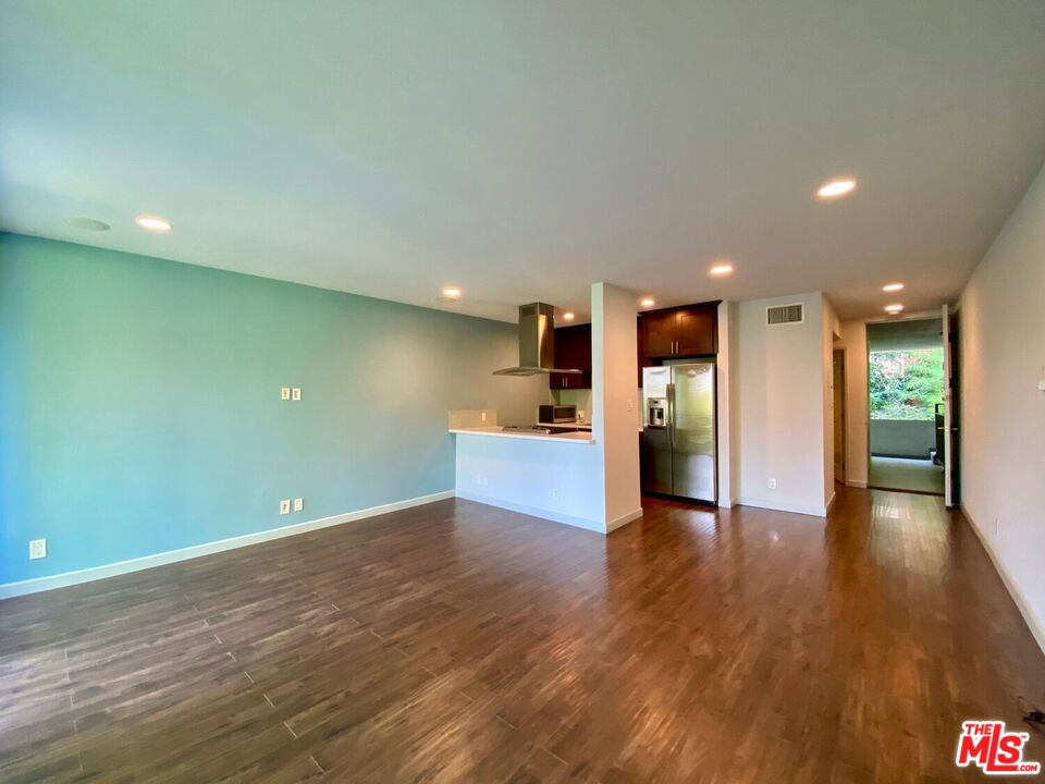 1920 Hillcrest Road, Unit 12 Los Angeles, CA 90068 - Photo 13 of 25 a view of a big room with wooden floor and a kitchen