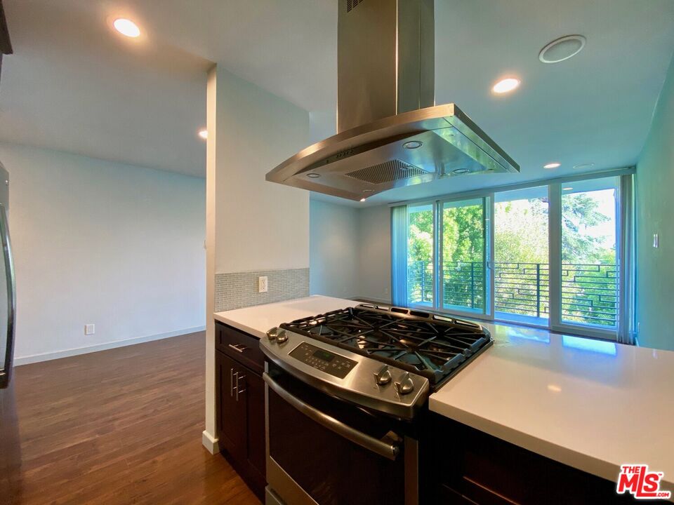 1920 Hillcrest Road, Unit 12 Los Angeles, CA 90068 - Photo 17 of 25 a kitchen with a stove and a refrigerator
