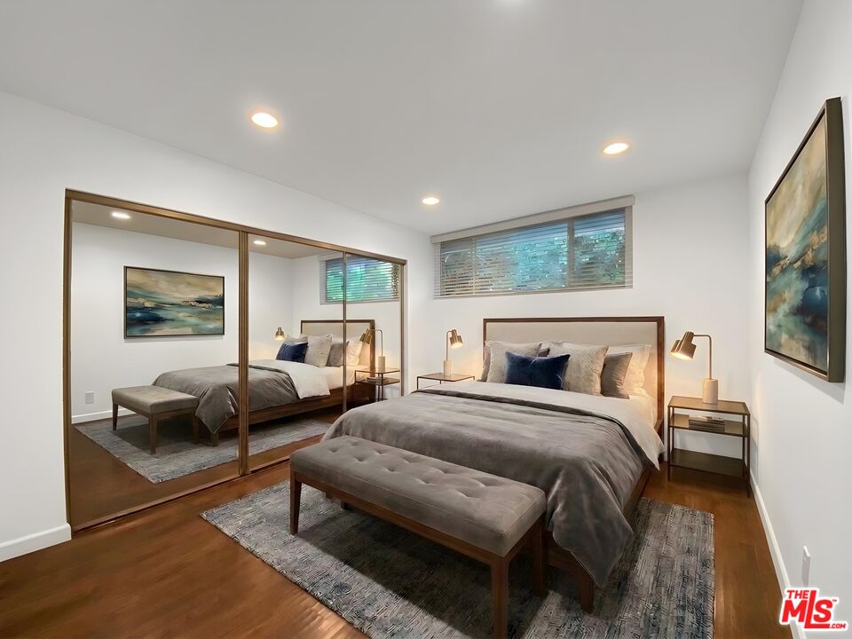 1920 Hillcrest Road, Unit 12 Los Angeles, CA 90068 - Photo 6 of 25 a bedroom with a bed and glass window
