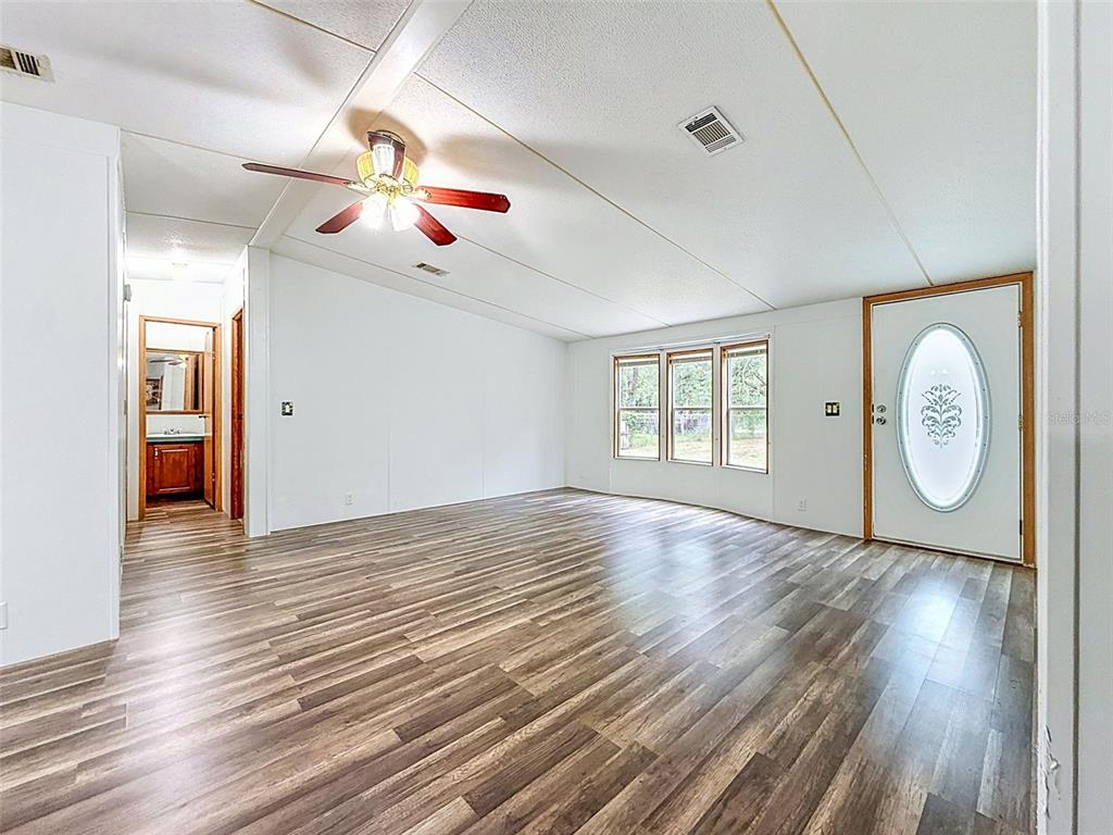 1819 Sinclair Hills Road Lutz, FL 33549 - Photo 20 of 60 a view of an empty room with window and wooden floor