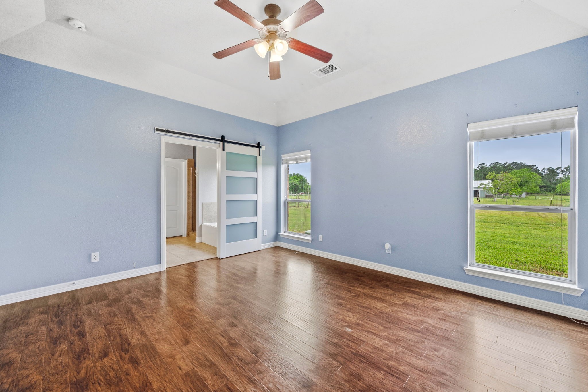 1405 Big Hill Road Winnie, TX 77665 - Photo 33 of 43 a view of an empty room with a window and wooden floor