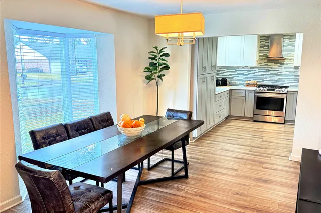 a view of a dining room with furniture and wooden floor