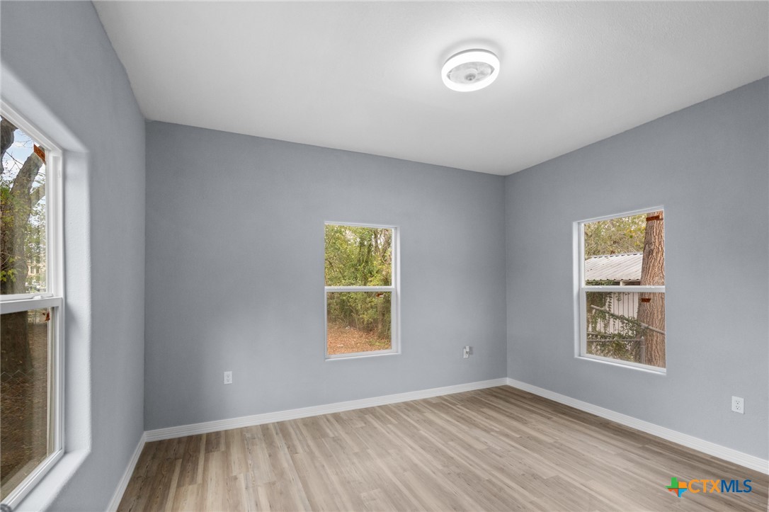 406 Hubbard Street Yoakum, TX 77995 - Photo 18 of 37 an empty room with windows