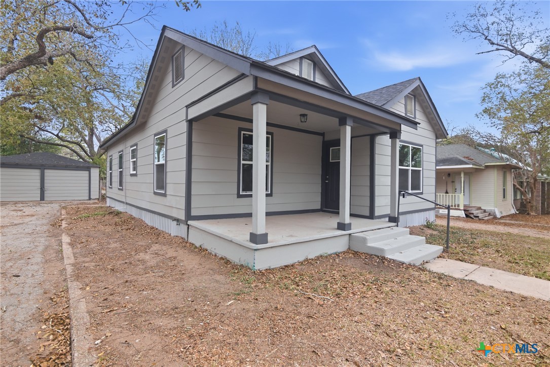 406 Hubbard Street Yoakum, TX 77995 - Photo 2 of 37 a front view of a house with a yard and garage