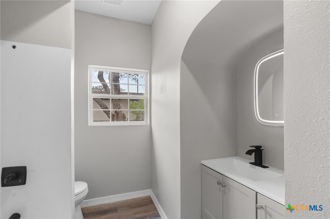 406 Hubbard Street Yoakum, TX 77995 - Photo 20 of 37 a bathroom with a sink a toilet and a window