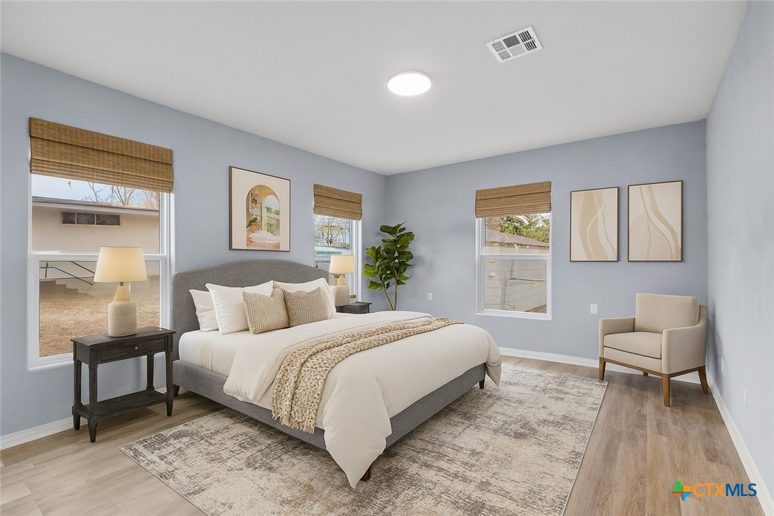 406 Hubbard Street Yoakum, TX 77995 - Photo 23 of 37 a bedroom with a bed and a table