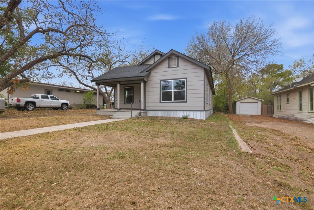406 Hubbard Street Yoakum, TX 77995 - Photo 3 of 37 a front view of a house with a yard and garage