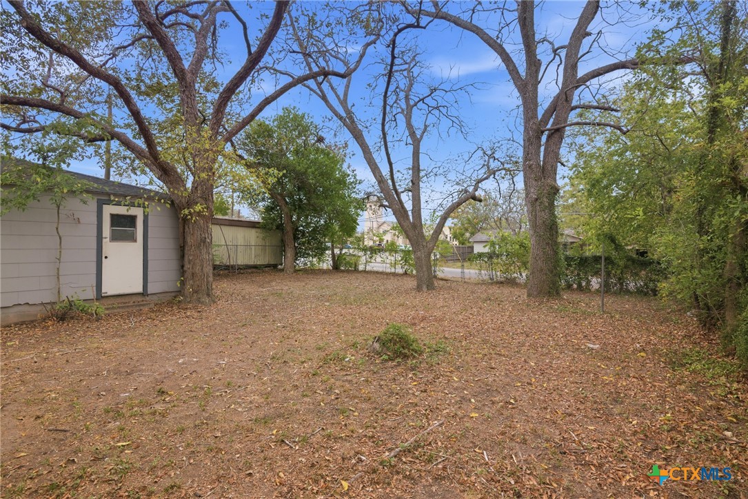 406 Hubbard Street Yoakum, TX 77995 - Photo 30 of 37 a view of large tree in front of a house
