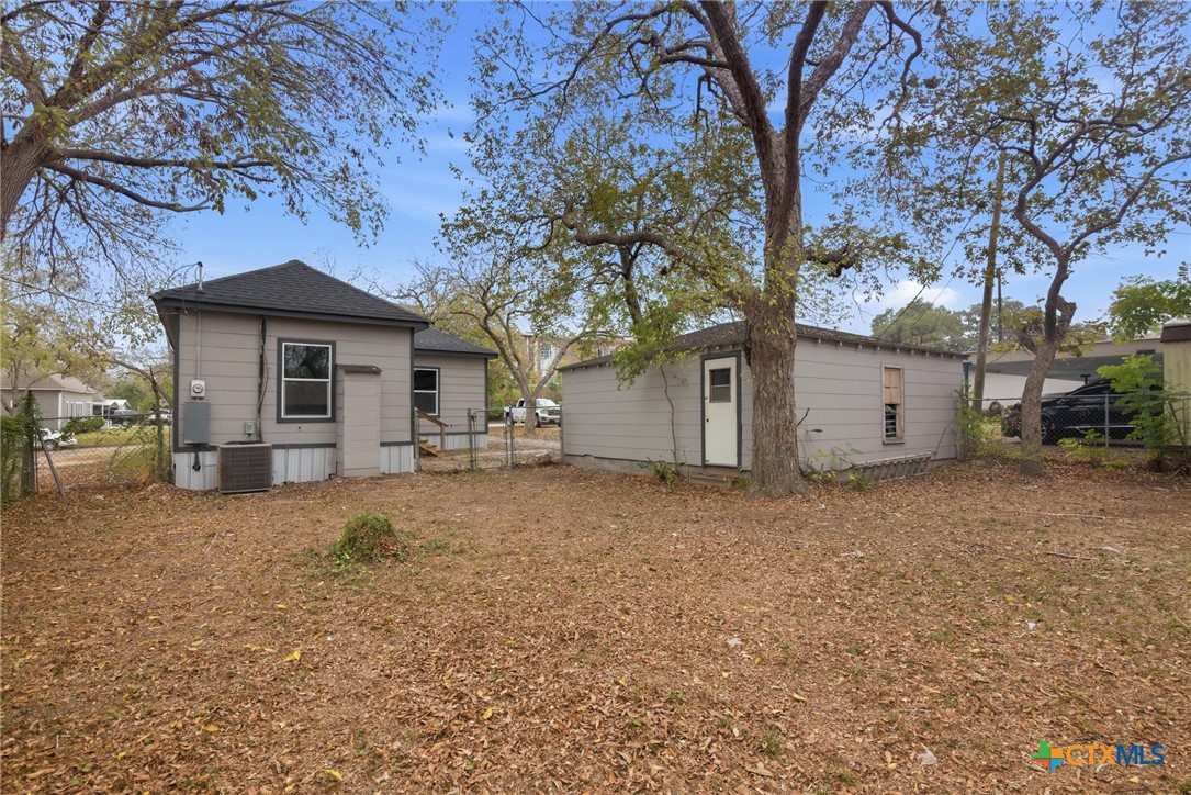 406 Hubbard Street Yoakum, TX 77995 - Photo 33 of 37 a view of a house with a yard and garage