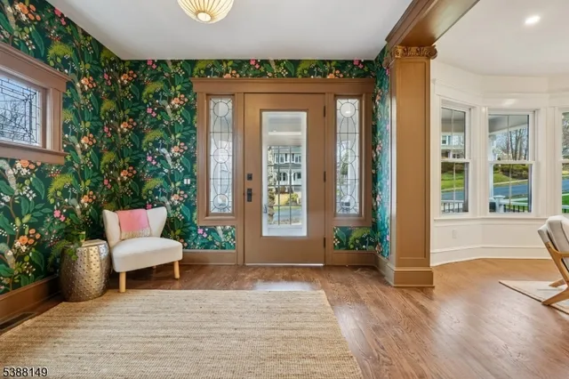 a living room with furniture a fireplace and a large window