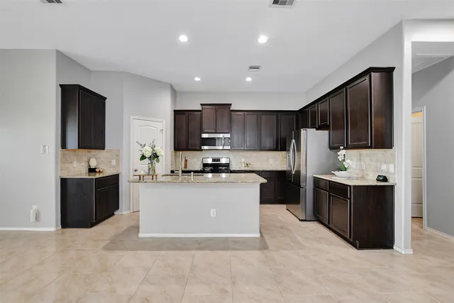 a bathroom with a sink double vanity granite tub and shower