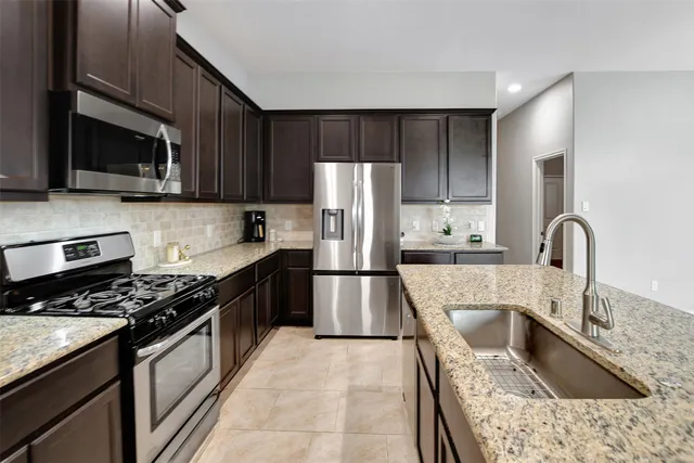 a view of a house with backyard sitting area and garden