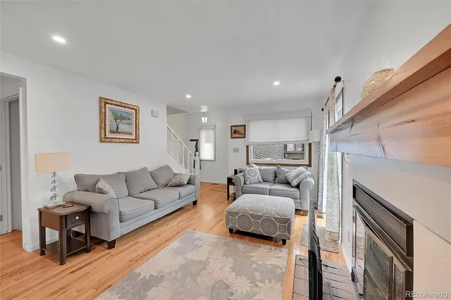 a living room with furniture and a ceiling fan