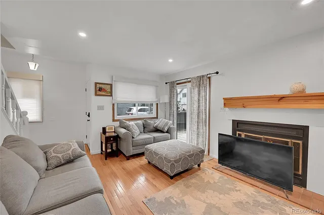 a living room with furniture a fireplace and a flat screen tv