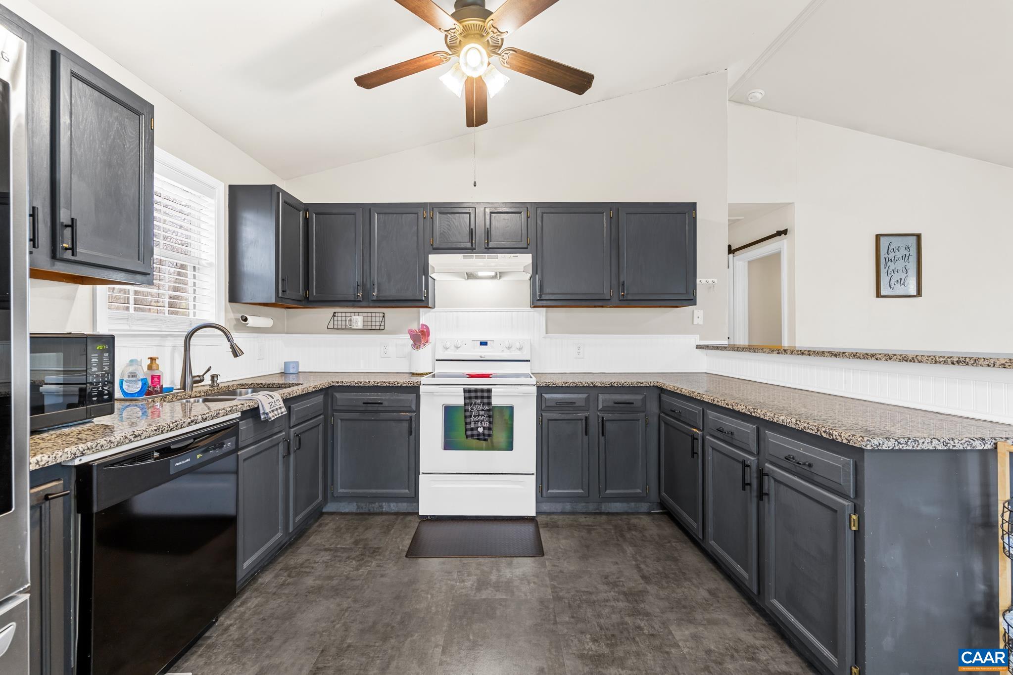 1029 West Daffodil Road Ruckersville, VA 22968 - Photo 18 of 39 a kitchen with a stove sink and cabinets