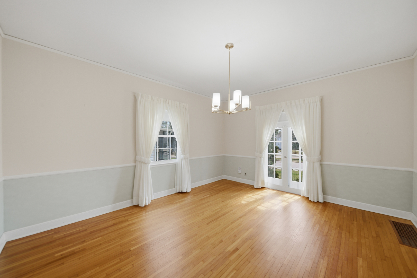 807 East Fellows Street Dixon, IL 61021 - Photo 20 of 31 an empty room with wooden floor chandelier and windows