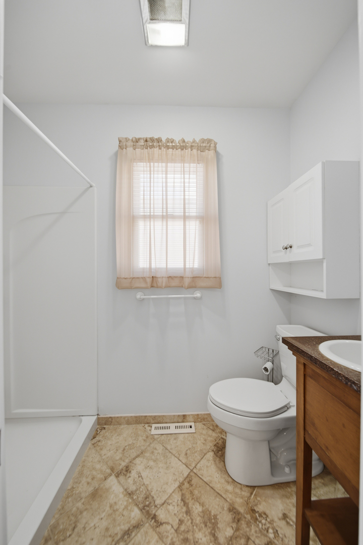 807 East Fellows Street Dixon, IL 61021 - Photo 22 of 31 a bathroom with a toilet a sink and a window