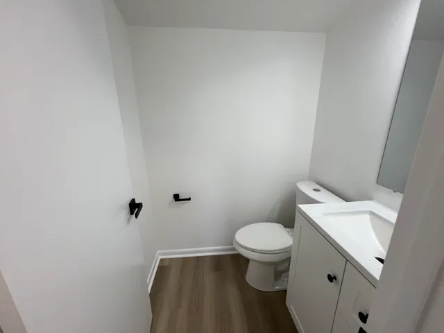 a kitchen with a table chairs and flat screen tv