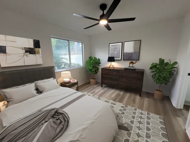 a bedroom with a large bed and a chandelier