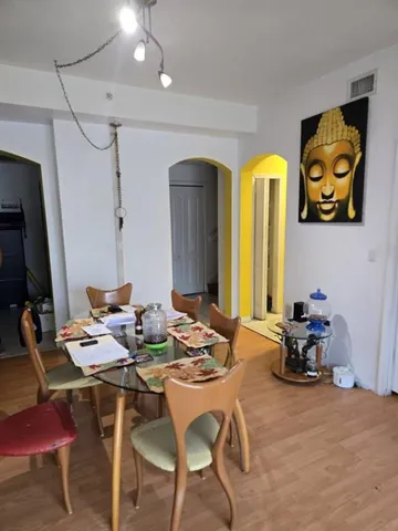 a dining room with furniture and a chandelier