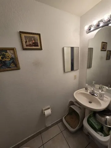 a bathroom with a toilet a sink and mirror