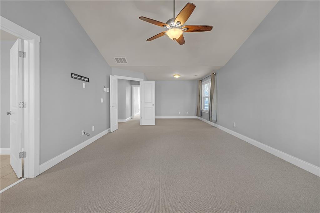 2048 Village Crest Drive Northwest Atlanta, GA 30318 - Photo 15 of 21 an empty room with a ceiling fan and a window