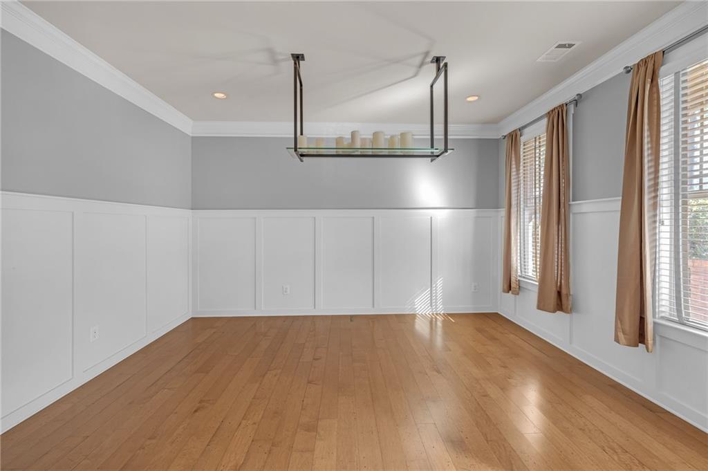 2048 Village Crest Drive Northwest Atlanta, GA 30318 - Photo 4 of 21 a view of empty room with wooden floor and fan