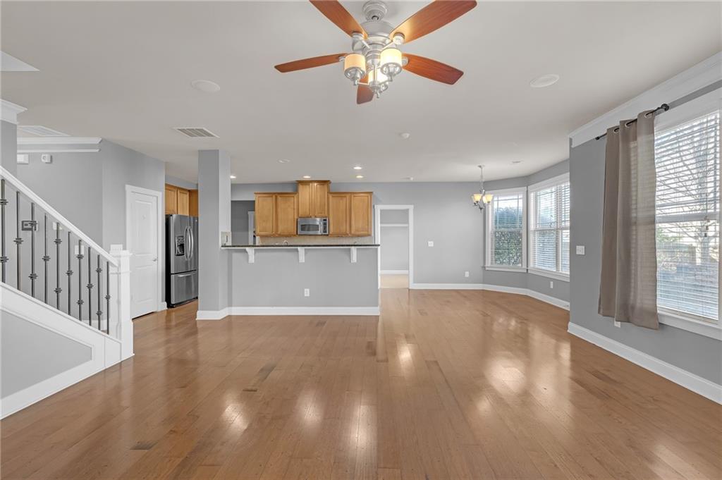 2048 Village Crest Drive Northwest Atlanta, GA 30318 - Photo 5 of 21 a view of a kitchen with a stove cabinets wooden floor and a window